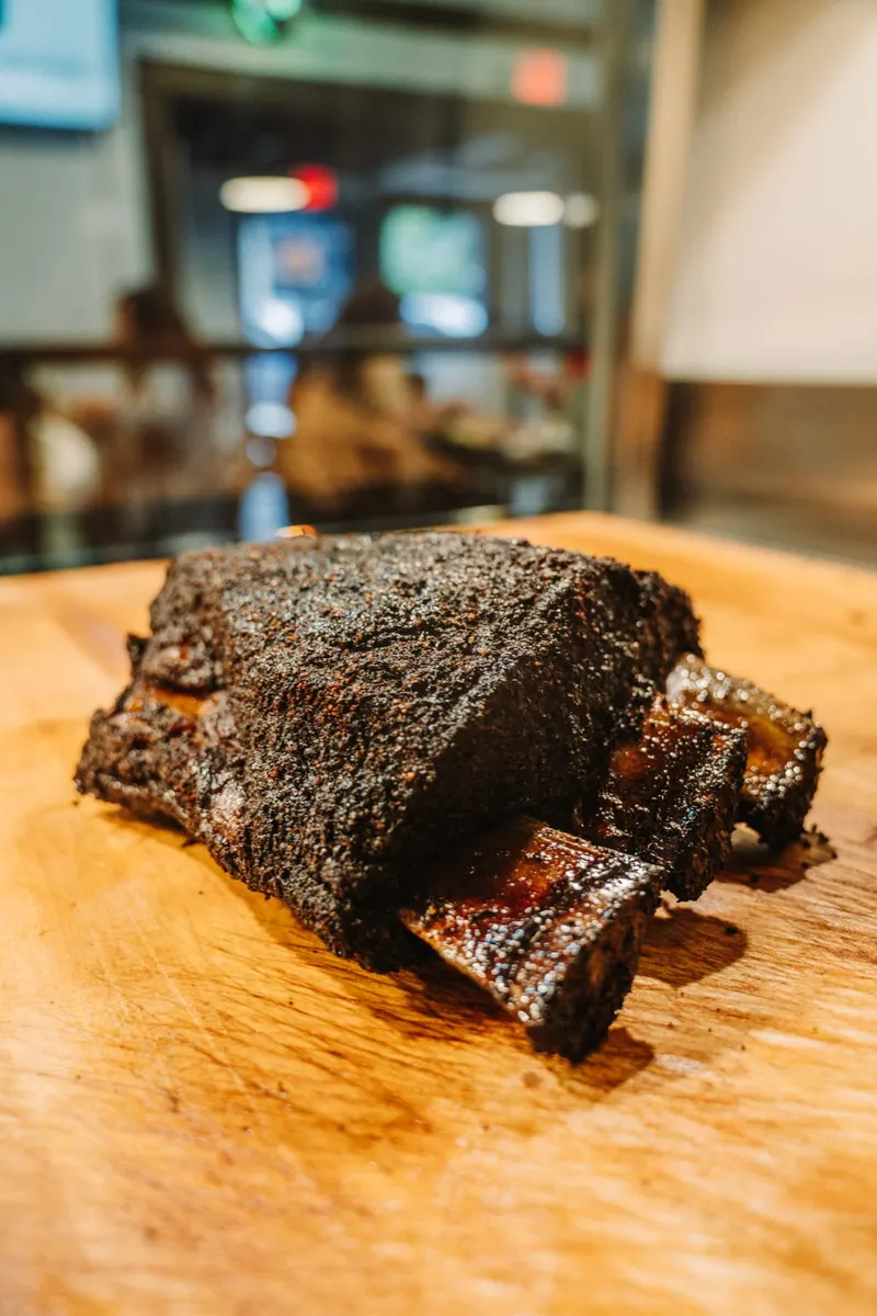 A smoked beef short rib on a cutting board